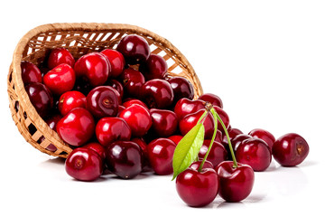 cherries in a wicker basket isolated on white background