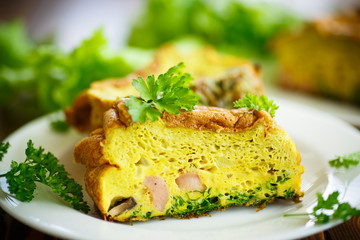 baked omelette with sausages and greens