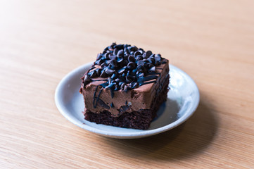 Dark chocolate cake on wood table
