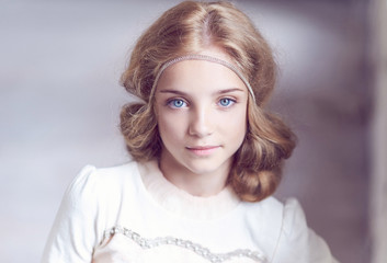 Portrait of cute blond blue eyes female teenager.