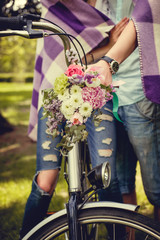 Naklejka premium Colorful flowers bouquet on bicycle handlebar.