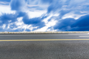 Fototapeta premium The new asphalt highway is under the blue sky