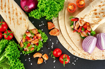 Burrito with grilled chicken and vegetables (fajitas, pita bread