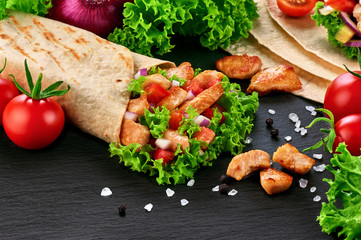 Burrito with grilled chicken and vegetables (fajitas, pita bread