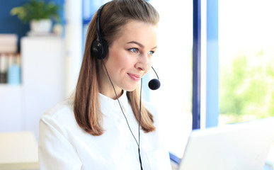 Female customer support operator with headset and smiling