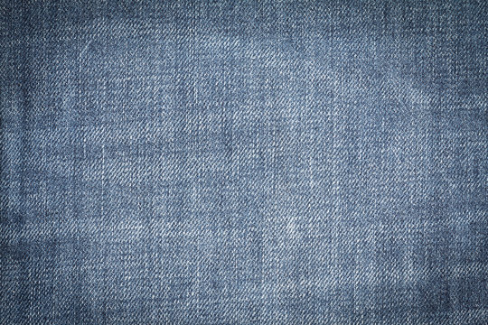 Closeup denim jeans texture. Stitched textured blue denim jeans background. Old grunge vintage denim jeans. Denim jeans fashion design. Dark edged.