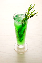 a refreshing cocktail with leaves of tarragon and ice