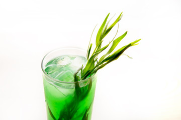 a refreshing cocktail with leaves of tarragon and ice