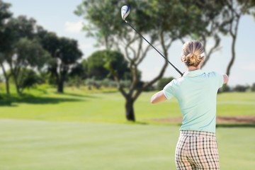 Rear view of woman playing golf 