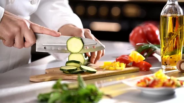 chef cutting vegetables on the work plan
