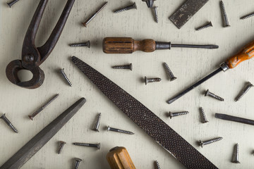 Accessory, assorted tools set on wooden light background. Construction assortment instruments for repairman, carpenter, builder. Copy space for text. Top view. 