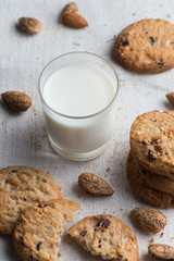 Cookies pile with chocolate chip and almond on light textile background. Delicious morning snacks for breakfast, brunch and lunch. Appetizing, healthy and fast food