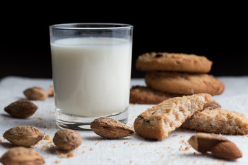 Cookies pile with chocolate chip and almond on light textile background. Delicious morning snacks for breakfast, brunch and lunch. Appetizing, healthy and fast food