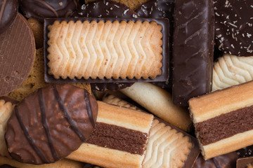 Cookies assorted on black background. Delicious morning snacks for breakfast, brunch and lunch. Appetizing, sweet and fast food.