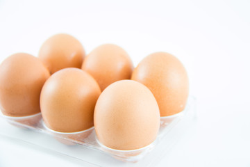 Six brown eggs in a case