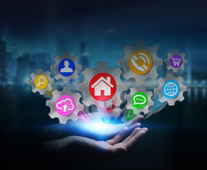 Businesswoman holding colorful cogwheel icons