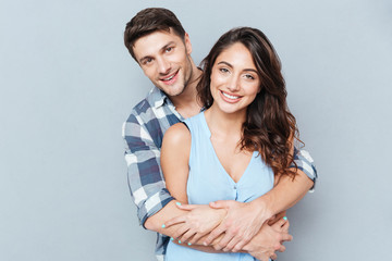Happy loving couple isolated over gray background