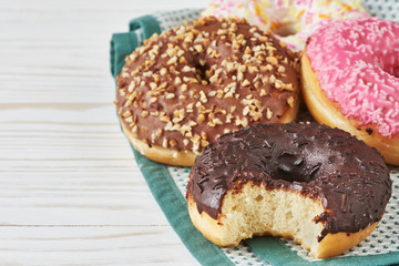 Colored donuts on wooden background