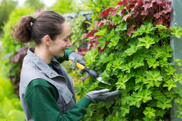 Young attractive woman working in a public garden