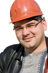 Portrait of a builder man in a jacket and a protective helmet on his head