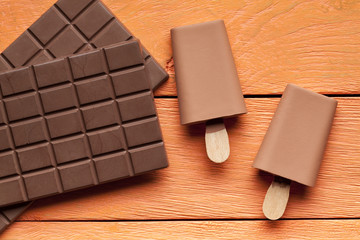 Ice lollies and bar of chocolate