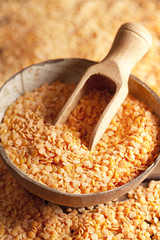 Red lentils in scoop and bowl