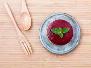 Strawberry cheesecake with fresh mint leaves on wooden backgroun