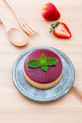 Strawberry cheesecake with fresh mint leaves on wooden backgroun