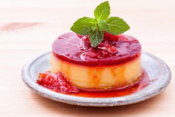 Strawberry cheesecake with fresh mint leaves on wooden backgroun