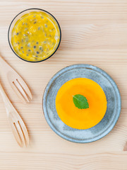 Passion fruit cheesecake with fresh mint leaves on wooden backgr