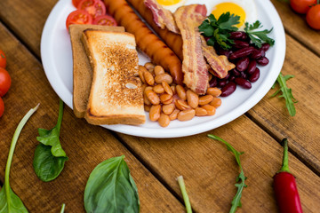 breakfast with fried eggs, sausages, toasts
