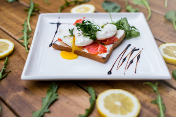 Sandwich with poached eggs with salmon and cream cheese. Top view