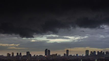 Cityscape of Bangkok before raining, dark huge nimbus clouds and the city in the evening