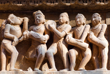 Sculptures of musicians on the external walls at Hindu temple in Khajuraho, India