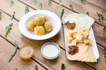 Obraz na płótnie Canvas Cheese, nuts, snacks, sauces