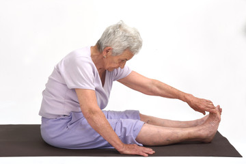 Senior woman doing yoga, isolated