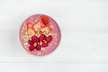 Healthy Pink Smoothie in the Bowl from Banana and Strawberries w