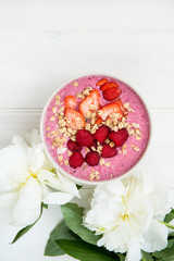 Healthy Pink Smoothie in the Bowl from Banana and Strawberries w