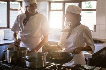 Chefs preparing food at stove
