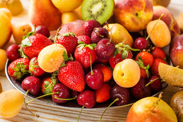 Fresh mixed fruits, berries on plate. Summer fruit, berry.
