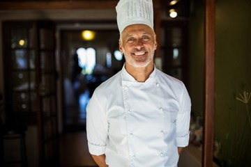 Portrait of chef standing with hands behind back