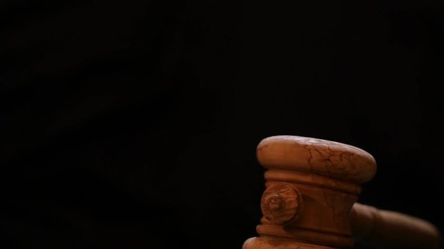 gavel hit slow motion dolly shot black background