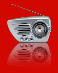 Silver retro radio on red with reflection