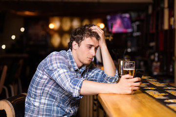 single man sitting at bar having a beer