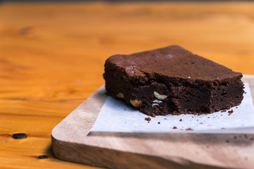 Chocolate brownie cake on a wooden background