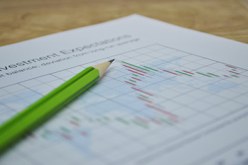Pencil on business graph, stock market concept