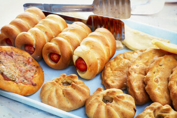 Delicious fresh mouthwatering pastries lay on the table for sale