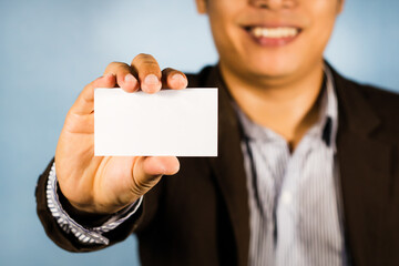 Asian business man show white card on hand and smile. empty card