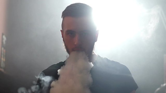 young man make a coil build on RDA in smoky vape shop