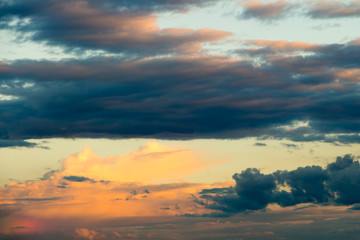 Beautiful cloudy sky with sun rays. Cloudy abstract background. Sunset light.